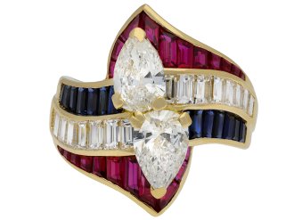 Mauboussin diamond, ruby and sapphire crossover ring, French, circa 1980.