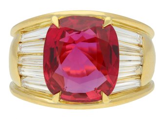 Vintage ruby and diamond flanked solitaire ring, circa 1970. 