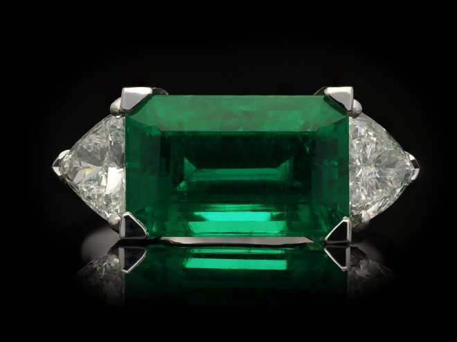 Colombian emerald diamond flanked solitaire ring hatton garden