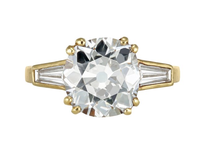 Old mine diamond flanked solitaire ring.
