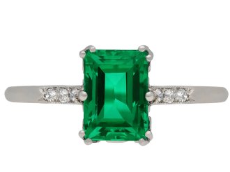 Colombian emerald and diamond flanked solitaire ring, circa 1920.