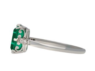 Colombian emerald and diamond flanked solitaire ring, circa 1920. Hatton Garden