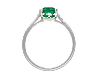 Colombian emerald and diamond flanked solitaire ring, circa 1920. Hatton Garden