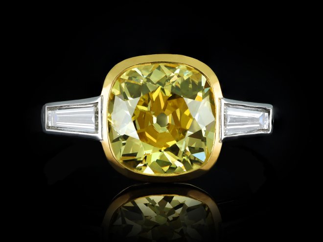 Fancy intense yellow diamond flanked solitaire ring, circa 1950.