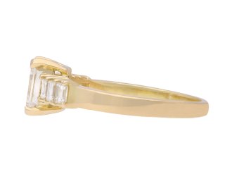 Emerald cut diamond flanked solitaire ring, circa 1970. Hatton Garden