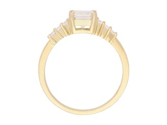 Emerald cut diamond flanked solitaire ring, circa 1970. Hatton Garden