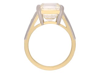 Emerald cut diamond flanked solitaire ring, circa 1970. Hatton Garden
