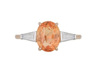 Padparadscha Ceylon sapphire and diamond flanked solitaire ring.