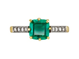 Colombian Emerald and diamond flanked solitaire ring, circa 1915.