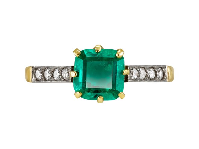 Colombian Emerald and diamond flanked solitaire ring, circa 1915.