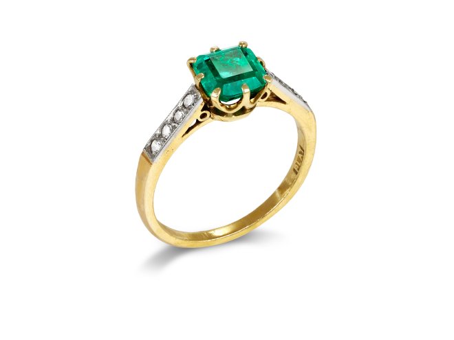 Colombian Emerald and diamond flanked solitaire ring, circa 1915.