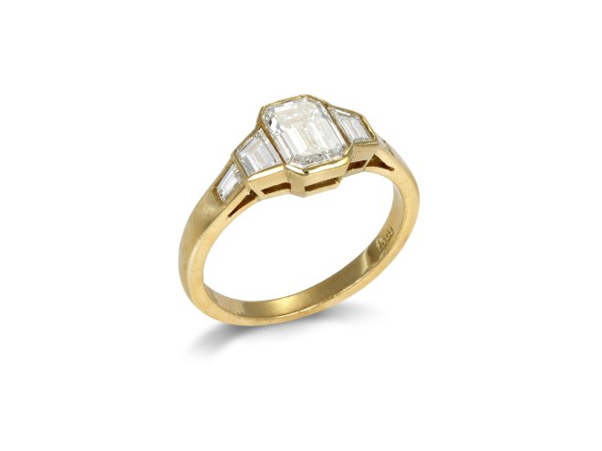 Vintage diamond flanked solitaire ring, circa 1970.
