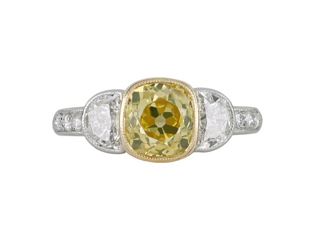 Fancy yellow diamond flanked solitaire ring, circa 1950.