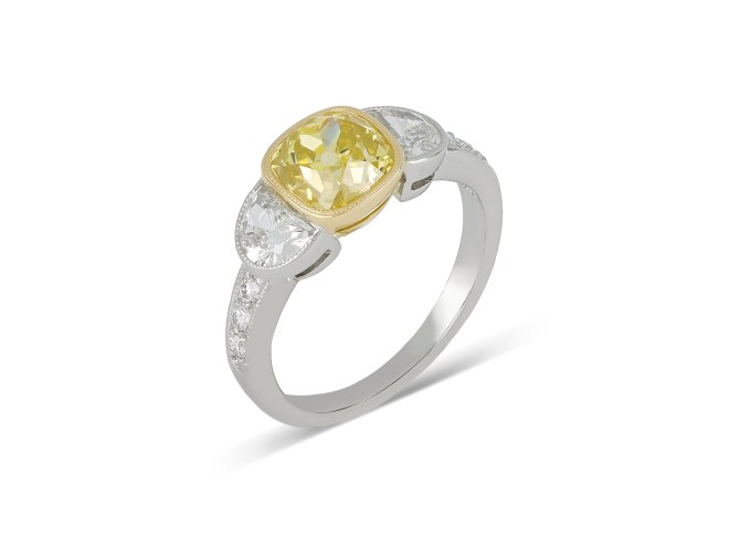 Fancy yellow diamond flanked solitaire ring, circa 1950.