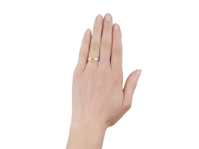 Fancy yellow diamond flanked solitaire ring, circa 1950.