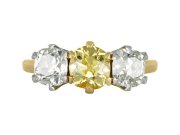 Fancy intense yellow diamond three stone ring, English, circa 1910. 