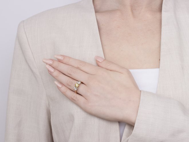 Fancy intense yellow diamond three stone ring, English, circa 1910. 