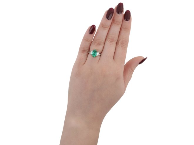 Emerald and diamond flanked solitaire ring, circa 1990