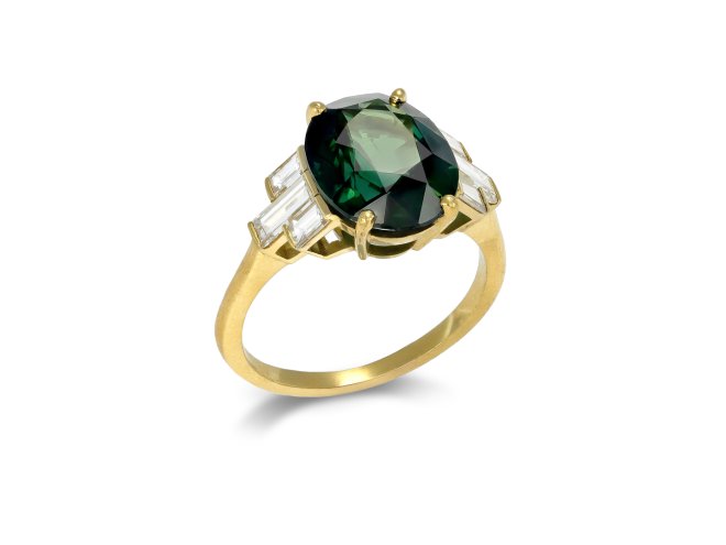 Green sapphire and diamond flanked solitaire ring. 
