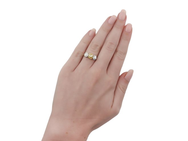 Fancy brownish orangy yellow diamond three stone ring, English, circa 1905.