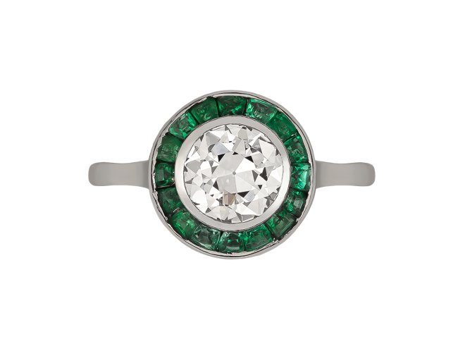 Diamond and emerald target ring, French, circa 1920. 