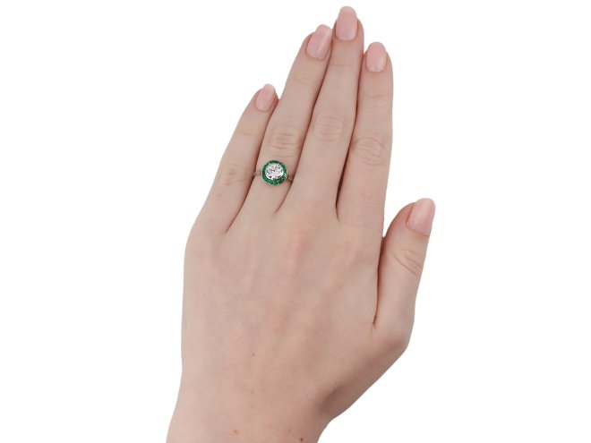 Diamond and emerald target ring, French, circa 1920. 