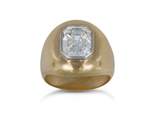 Emerald cut diamond gypsy ring, circa 1970.