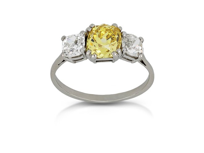Fancy intense yellow diamond three stone ring, circa 1915