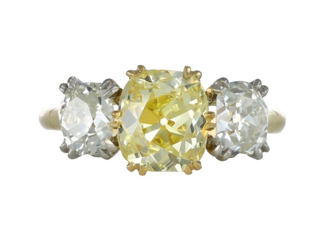 Fancy intense yellow diamond three stone ring, English, circa 1910.