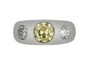 Fancy intense yellow diamond three stone gypsy ring, circa 1950.