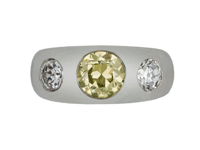 Fancy intense yellow diamond three stone gypsy ring, circa 1950.