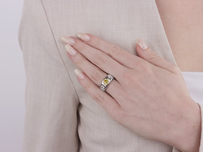Fancy intense yellow diamond three stone gypsy ring, circa 1950.