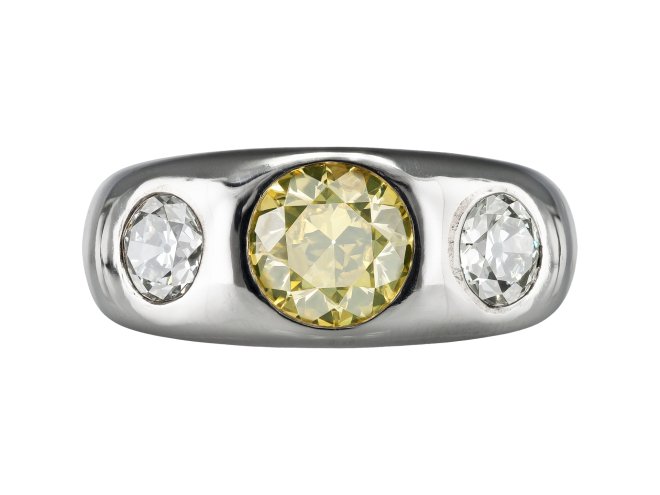 Fancy intense yellow diamond three stone gypsy ring, circa 1950.