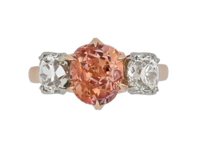Padparadscha Ceylon sapphire and diamond three stone ring.