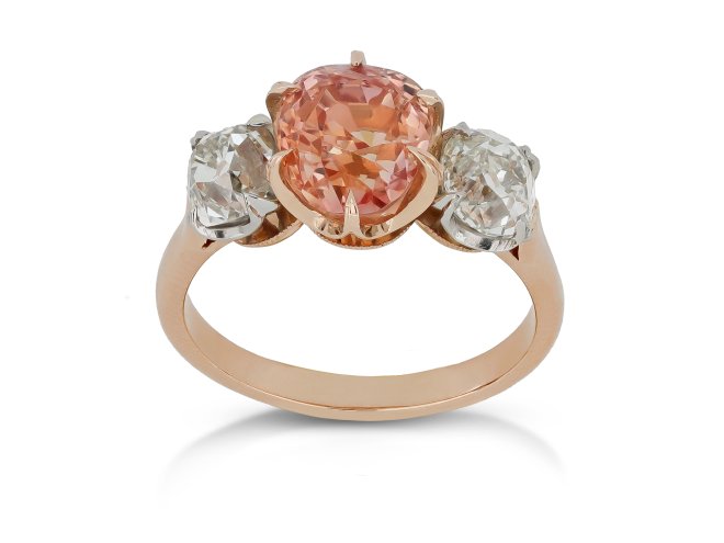 Padparadscha Ceylon sapphire and diamond three stone ring.
