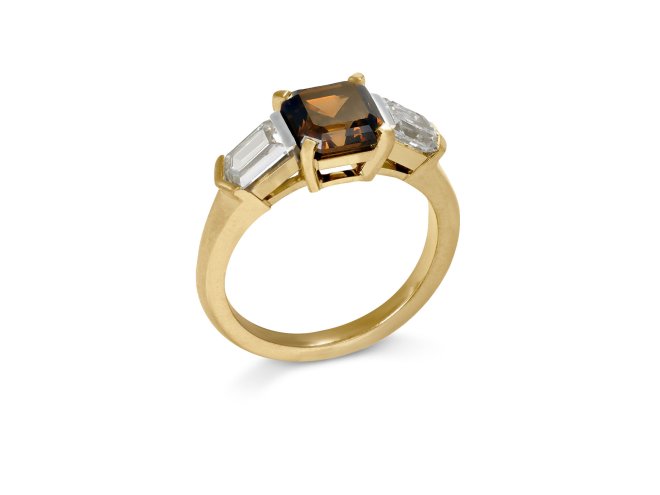 Brown diamond flanked solitaire ring. 