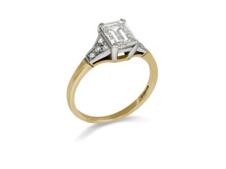 A diamond ring featuring an emerald cut centre stone