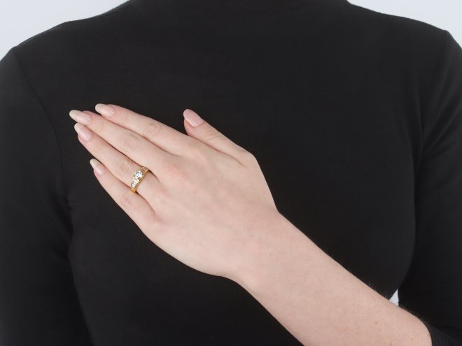 Diamond flanked solitaire ring, circa 1970.