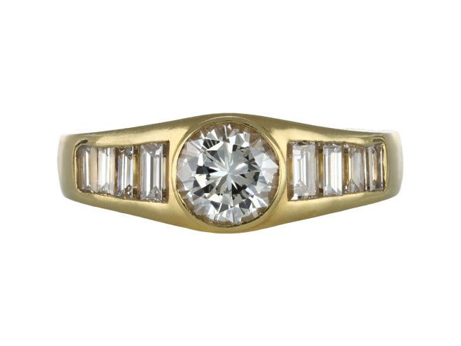 Diamond flanked solitaire ring, circa 1970.