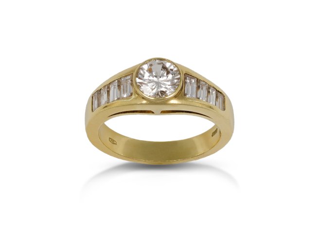 Diamond flanked solitaire ring, circa 1970.