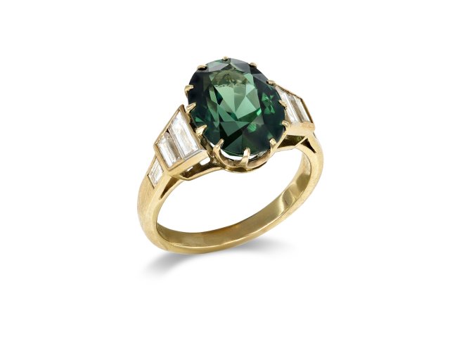 Green sapphire and diamond flanked solitaire ring. 