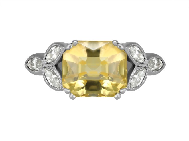 Yellow Ceylon sapphire and diamond flanked solitaire ring, circa 1950. 