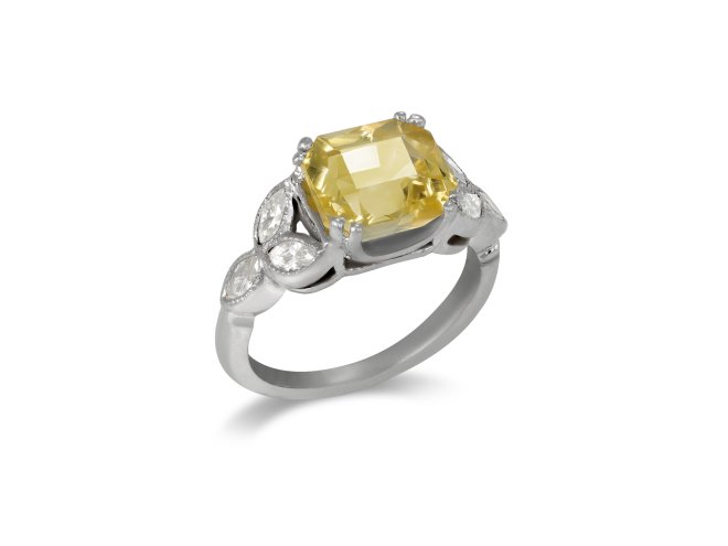 Yellow Ceylon sapphire and diamond flanked solitaire ring, circa 1950. 