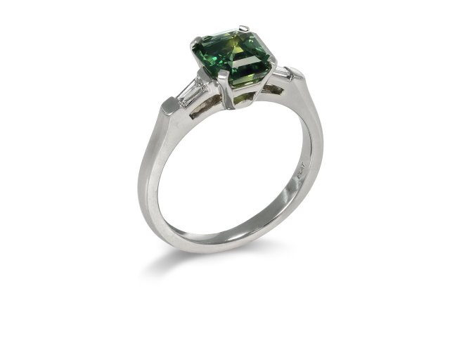 Green sapphire and diamond flanked solitaire ring. 