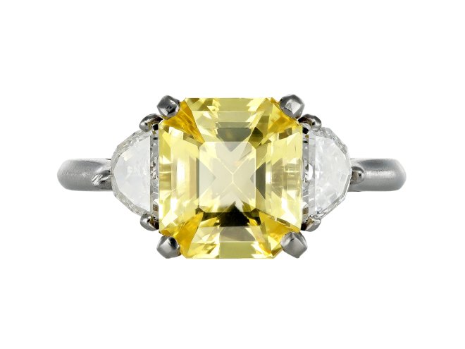 Yellow Ceylon sapphire and diamond flanked solitaire ring. 