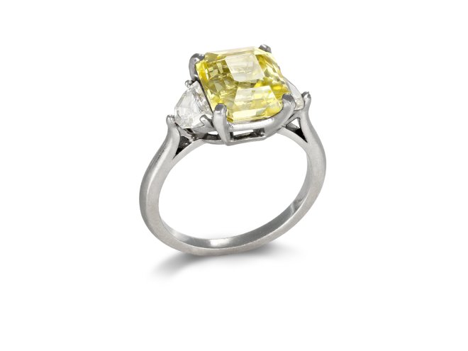 Yellow Ceylon sapphire and diamond flanked solitaire ring. 