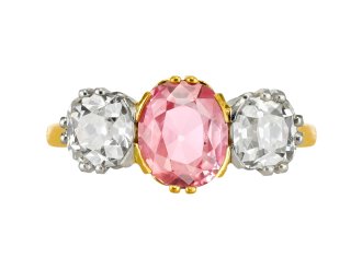 Padparadscha Ceylon sapphire and diamond three stone ring, circa 1910.