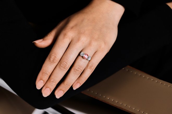 Padparadscha Ceylon sapphire and diamond three stone ring, circa 1910.