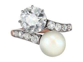 Natural pearl and diamond crossover ring, circa 1910. 