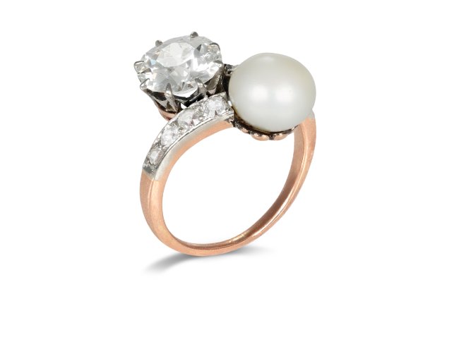 Natural pearl and diamond crossover ring, circa 1910. 